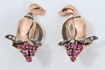 Lot 334 - Pair of 1940s rose gold diamond and ruby cocktail earrings in the form of a stylized flower, with clip fittings. Approximately 30mm.