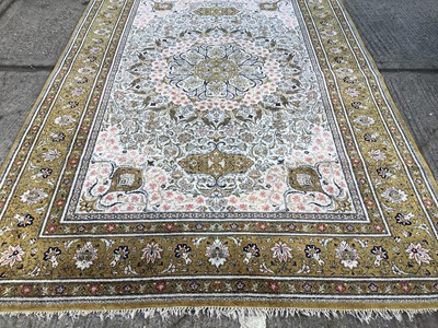 Lot 1013 - Kashan part rug silk, with cream ground and petalled medallion and concentric bird and foliate surround, in multiple bronze borders and tassel ends, approximately 220 x 310cm