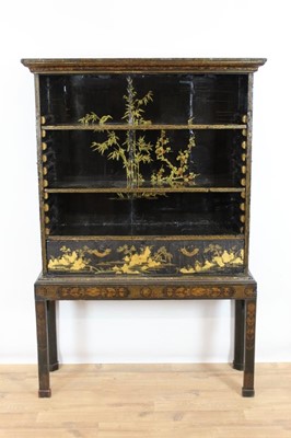 Lot 1006 - 18th century chinoiserie lacquered open cabinet with adjustable shelves, flanking brass handles and single drawer, on later stand with pierced brackets and chamfered legs, 111cm wide x 34cm deep x...