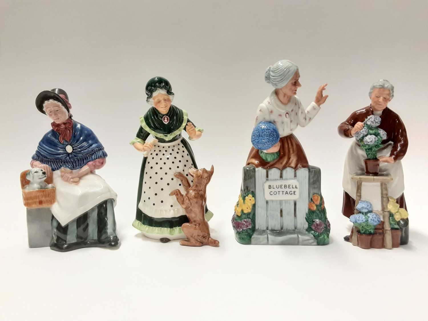 Lot 71 - Four Royal Doulton figures - Thank You HN2732, Flora HN2349, New Companions HN2770 and Old Mother Hubbard HN2314