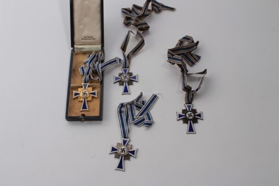 Lot 617 - Nazi German Mothers' Cross Gold Award in box of issue, together with two silver awards and one bronze award (4)