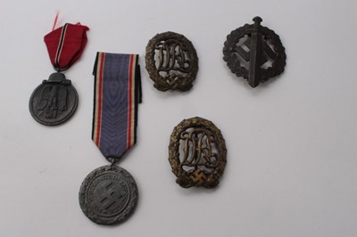 Lot 618 - Two Nazi German National Badge for Physical Training, together with a Nazi SA Sports badge, Nazi medal for the Winter campaign in Russia 1941 - 42 and a Nazi Civil Defence Medal (possibly later cop...