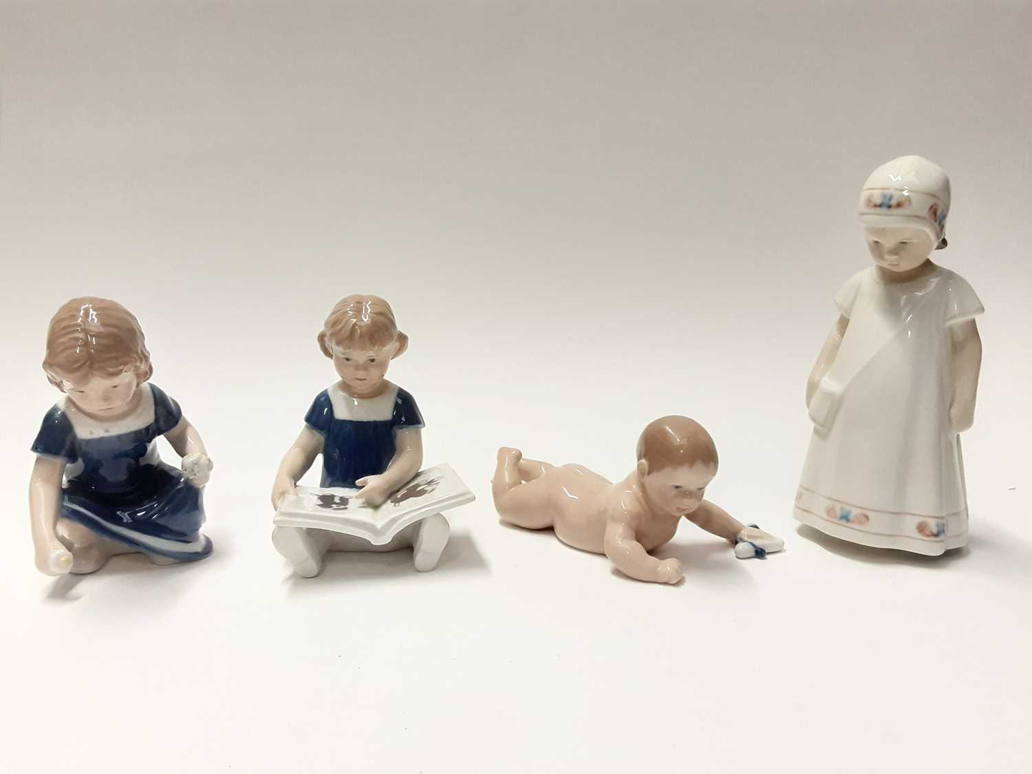Lot 151 - Four Royal Copenhagen porcelain figures including girl with book, model numbers 672, 674, 112 and 404