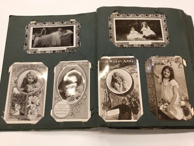 Lot 1412 - Early 20th century postcard album containing postcards, Christmas cards, and birthday cards