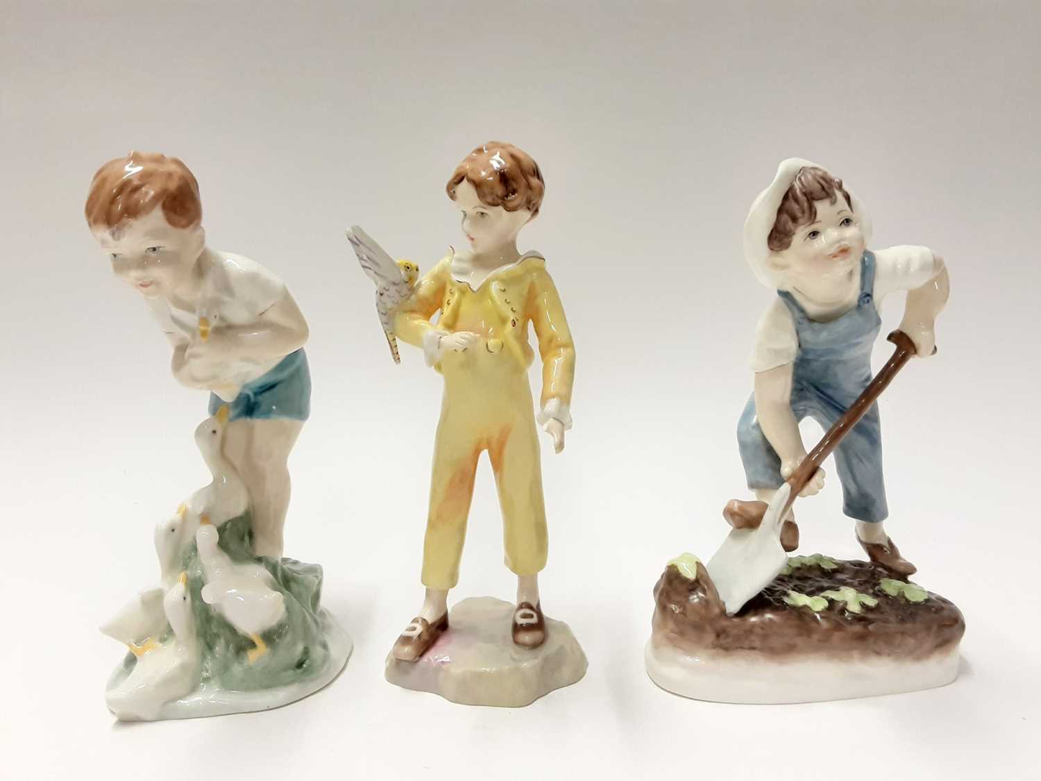 Lot 202 - Five Royal Worcester figures - Young Farmer 3433, The Parakeet 3087, Saturday's child works hard for a living 3262, Rosie Picking Apples and See-Saw