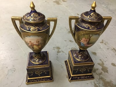 Lot 372 - Pair of 19th century Vienna style porcelain urns and covers, raised on integral square socles, together with Noritake twin handled vase and similar pair, pair of Doulton vases