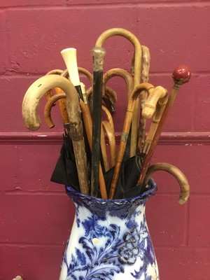 Lot 69 - Victorian pottery jardiniere housing collection of antique walking sticks and parasols