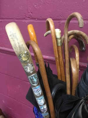 Lot 69 - Victorian pottery jardiniere housing collection of antique walking sticks and parasols