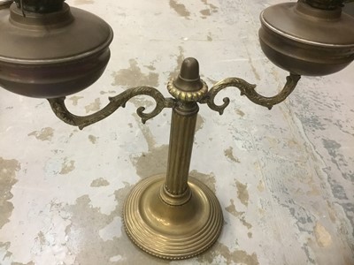 Lot 386 - Antique brass oil lamp with twin shades.