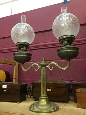 Lot 386 - Antique brass oil lamp with twin shades.