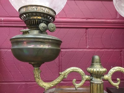 Lot 386 - Antique brass oil lamp with twin shades.