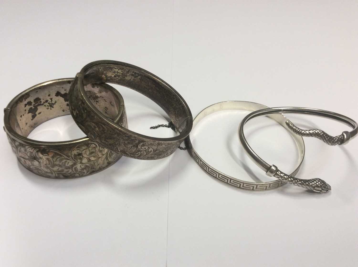 Greek Design Bangles Lot 505 - Two engraved hinged silver bangles, silver