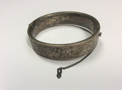 Lot 505 - Two engraved hinged silver bangles, silver snake torque bangle and silver Greek key design bangle (4)