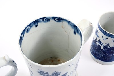 Lot 3 - Lowestoft cylindrical mug, with a spreading foot and scrolled handle, boldly painted in blue with flowers and leaves, a spring and an insect to reverse, a diaper and half floret border below the in...