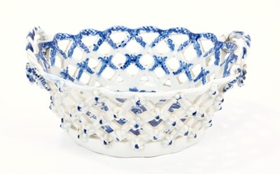 Lot 11 - Lowestoft basket, of smaller oval form, the latticework pierced sides applied with florets at the intersections, printed in blue with the Pinecone pattern, the interior with an elaborate painted bo...