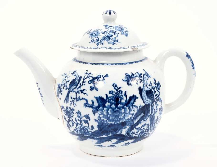 Lot 14 - Lowestoft teapot and cover, of globular form, printed in blue with a variant of the Birds in Branches pattern, within loop borders, 15cm high