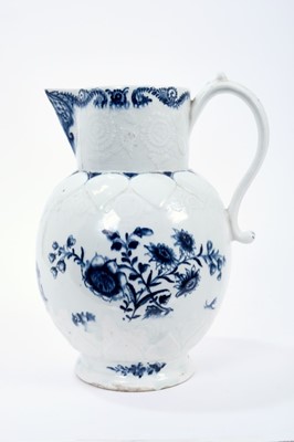 Lot 16 - Lowestoft jug, of large size, the neck moulded with flowers and leaves, lappets and florets around the shoulder and foot, painted in blue with flowering plants, painter's number 5 inside footrim, 2...