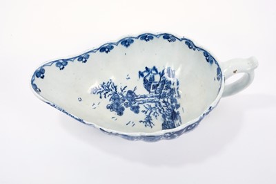 Lot 17 - Lowestoft sauceboat, of flat bottomed form with reeded sides, the interior printed in blue with a 'doughnut' tree, an elaborate painted border to the outside, 22cm long