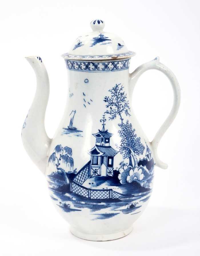 Lot 19 - Lowestoft coffee pot and cover, with a curved spout and button finial, painted in blue with a Chinese river scene within diaper borders, 23.5cm high