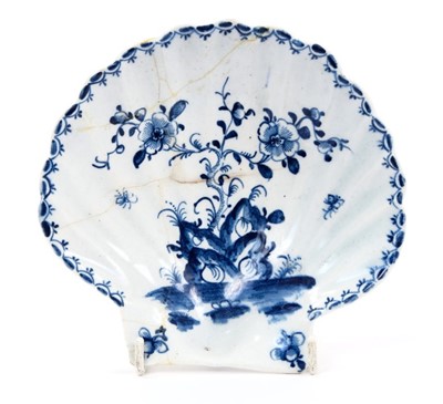 Lot 20 - Large Lowestoft scallop-shell dish, painted in blue with flowers issuing from rockwork, moths in flight around and a 'berry' border inside the rim, 14.2cm long