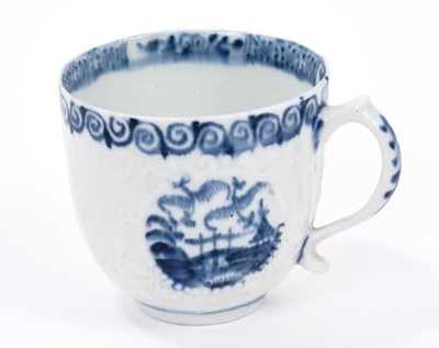 Lot 21 - Lowestoft coffee cup, with a scrolled handle, moulded in relief in Hughes style with flowers, diaper panels and three circular panels painted in blue with different Chinese scenes, scrolled border...