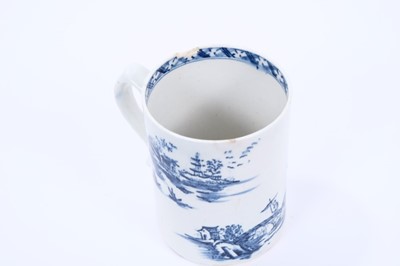 Lot 31 - Lowestoft mug, of small cylindrical form with a scrolled handle, printed in blue with a Chinese river landscape, a diaper border below the interior rim, 8.8cm high