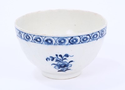 Lot 33 - Lowestoft tea bowl, moulded with panels painted in blue with flowers, moulded flowers in between, within a blue cell border, 7.5cm diameter