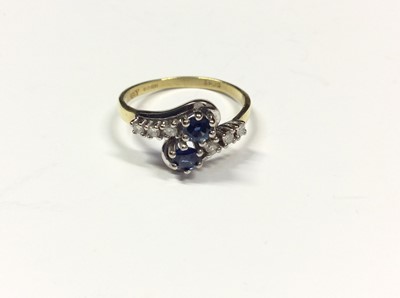 Lot 518 - 18ct gold sapphire and diamond crossover ring. Size P