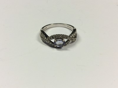 Lot 520 - 18ct white gold pale purple/blue stone and diamond ring. Size P