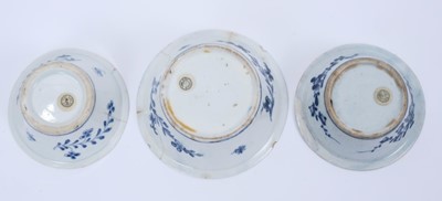 Lot 40 - Three Lowestoft patty pans, the first painted in blue with flowers within a berry border, painter's number 6 inside footrim, the other two painted with a moth within a berry border, between 9cm and...