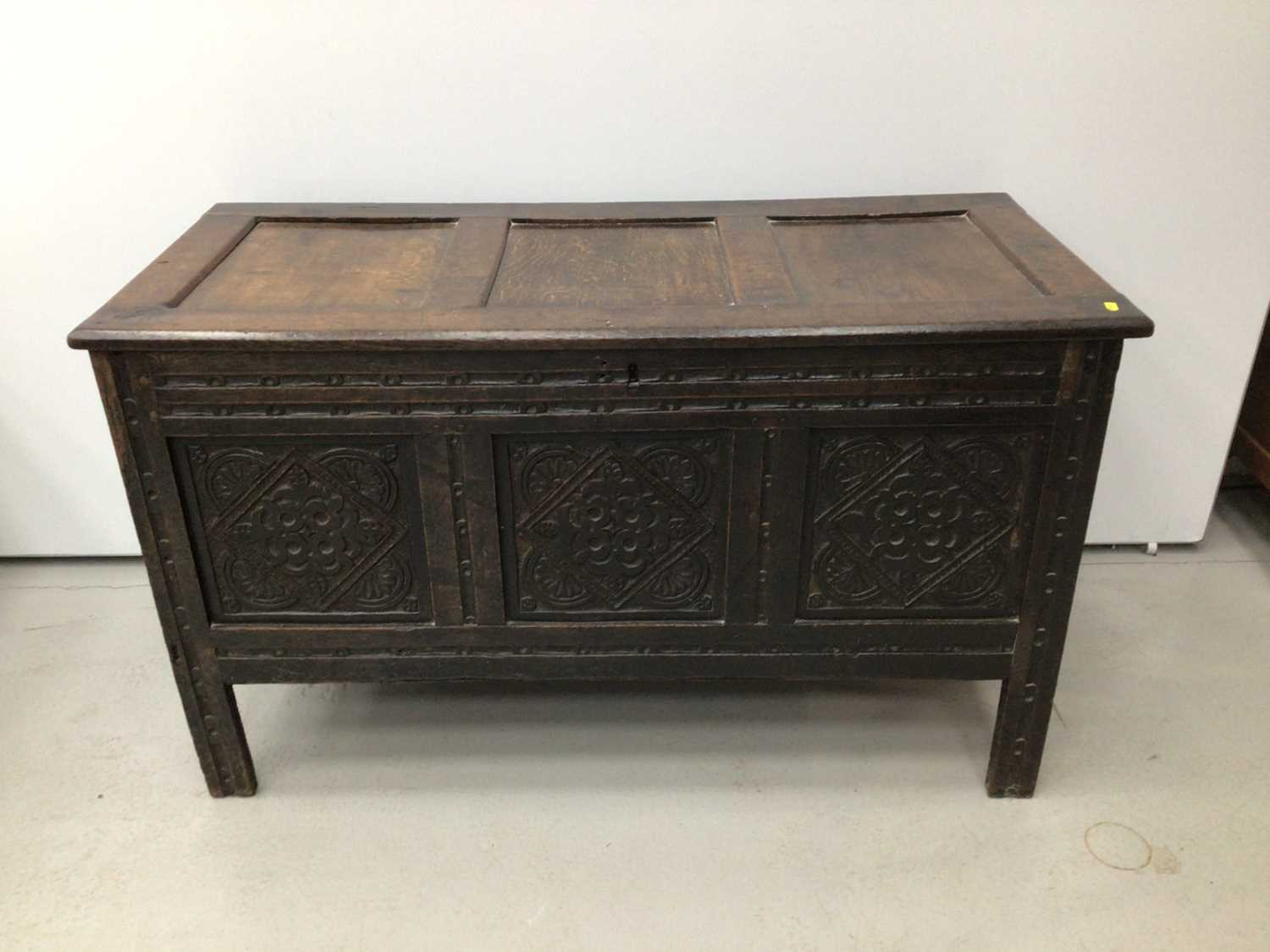Lot 66 - Good 17th century oak coffer, with triple panel top and lozenge carved triple panel front raised on stiles 120cm wide x 53cm deep x 70cm high