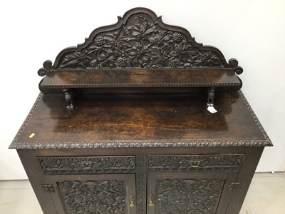 Lot 69 - Impressive 19th century Arts and Crafts carved oak Chiffonier, with arched gallery and shelf back raised on dragon supports, having two drawers and cupboards below on styles, allover relief carved...