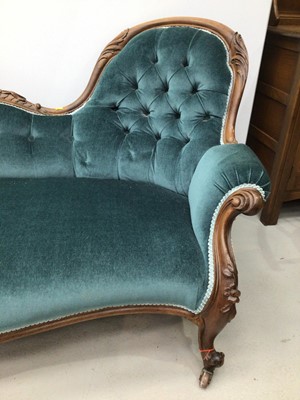 Lot 70 - Victorian double ended button upholstered sofa, with carved rosewood showwood frame and blue button upholstery on cabriole legs and castors