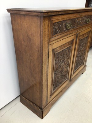 Lot 73 - Late Victorian carved walnut cupboard, with frieze drawer and pair of panelled doors belowm carved with mask and scroll ornament, 116 x 36cm deep x 98cm high
