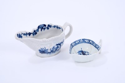 Lot 44 - Two Lowestoft butter boats, the first of gadrooned form, painted in blue with the Two Porter pattern, a floral border on the interior rim, painter's number 7 inside footrim, 11cm long, the second o...