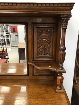 Lot 95 - Edwardian carved oak two height sideboard with mirrored back, Corinthian column supports, drawers and cupboards below.