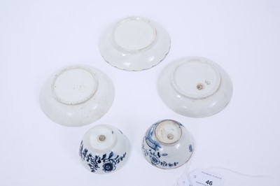 Lot 46 - Lowestoft tea bowls and saucers, including a tea bowl painted in blue with trailing flowers, another printed with flowering plants within a fenced enclosure,  a fluted saucer printed with panels of...