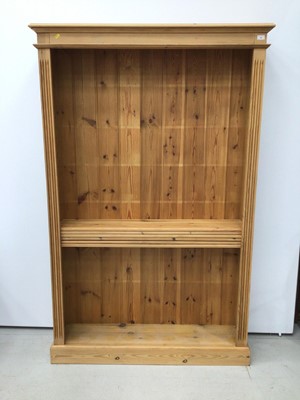 Lot 98 - Pine open bookcase with adjustable shelves, moulded cornice and fluted decoration to the front, 127cm wide x 198cm high x 30cm deep.