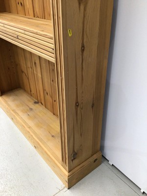 Lot 98 - Pine open bookcase with adjustable shelves, moulded cornice and fluted decoration to the front, 127cm wide x 198cm high x 30cm deep.