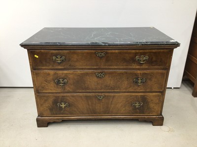 Lot 99 - George II style walnut chest of three long drawers with associated green marble top, the drawers with brass handles and crossbanded moulded edge, on bracket feet, 112cm wide x 59cm deep x 75cm high