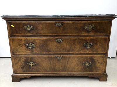 Lot 99 - George II style walnut chest of three long drawers with associated green marble top, the drawers with brass handles and crossbanded moulded edge, on bracket feet, 112cm wide x 59cm deep x 75cm high