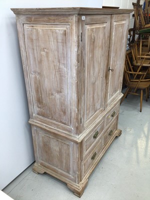 Lot 120 - Georgian style limed oak two height cupboard, with shelved upper section enclosed by pair of feielded panelled doors, the base with four short drawers on ogee bracket feet, 113cm wide x 57cm deep x...