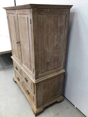 Lot 120 - Georgian style limed oak two height cupboard, with shelved upper section enclosed by pair of feielded panelled doors, the base with four short drawers on ogee bracket feet, 113cm wide x 57cm deep x...