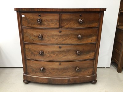 Lot 126 - Victorian mahogany bow front chest of two short and three long graduated drawers with flame mahogany veneers and turned handles on bun feet with castors, 120cm wide x 118cm high x 62cm deep