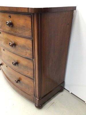 Lot 126 - Victorian mahogany bow front chest of two short and three long graduated drawers with flame mahogany veneers and turned handles on bun feet with castors, 120cm wide x 118cm high x 62cm deep