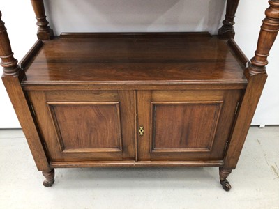 Lot 129 - Late Victorian carved walnut buffet with carved pediment to the back, turned supports and cupboard below enclosed by two panelled doors on turned legs with castors, 90cm wide x 113cm high x 42cm de...