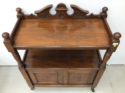 Lot 129 - Late Victorian carved walnut buffet with carved pediment to the back, turned supports and cupboard below enclosed by two panelled doors on turned legs with castors, 90cm wide x 113cm high x 42cm de...