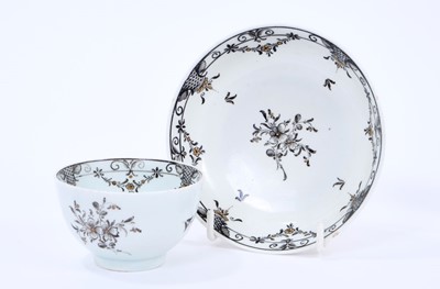 Lot 52 - Lowestoft tea bowl and saucer, pencilled in black with flower sprays and formal borders of diaper and flower garlands, picked out in gold, saucer 11.2cm diameter