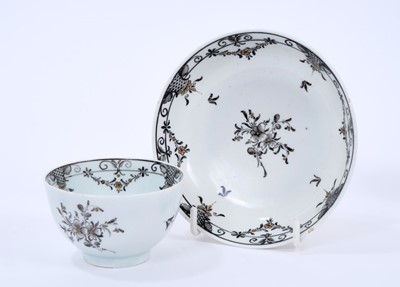 Lot 52 - Lowestoft tea bowl and saucer, pencilled in black with flower sprays and formal borders of diaper and flower garlands, picked out in gold, saucer 11.2cm diameter