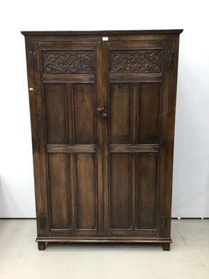 Lot 140 - Oak double wardrobe enclosed by two carved and panelled doors, 118cm wide, 48cm deep, 178cm high